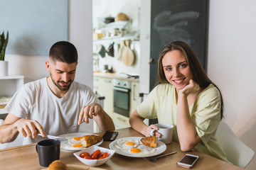 Obraz na płótnie Canvas happy romantic couple having breakfast at home