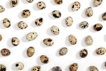 Quail eggs pattern. Big collection of quail eggs on white background. Easter concept. Flat lay, top view, copy space
