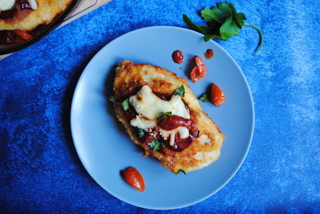 Roasted Chicken Breast slice with Cheddar and Parmesan in a Grey plate - top view