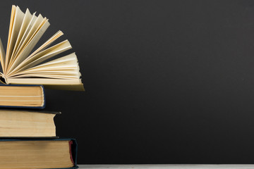 Open book, hardback books on wooden table. Back to school. Copy space