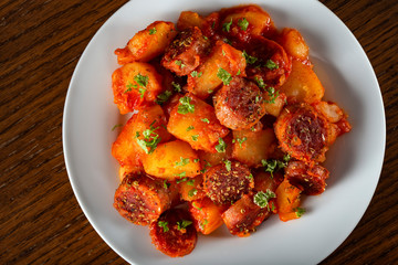 Potatoes stew with pork sausages
