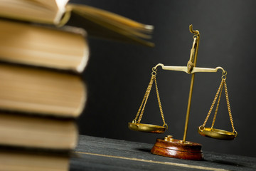 Law concept - Open law book with a wooden judges gavel on table in a courtroom or law enforcement office isolated on white background. Copy space for text.