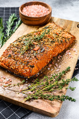 Hot smoked salmon fillet on a cutting Board. trout. Gray background, top view.