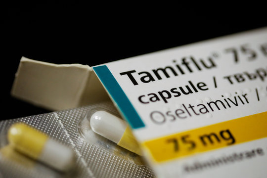 Close up image with a Tamiflu capsule (oseltamivir) on a blister pack, an antiviral medication that blocks the actions of influenza virus types A and B the human body.
