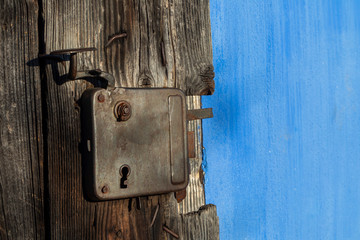 Vintage door latch. Detail of Old traditional Romanian blue house. Old door in Sibiu, Romania