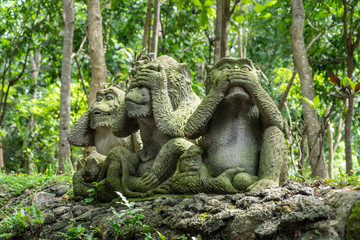 Three monkeys statue in Sacred Monkey Forest, Ubud, Bali, Indonesia