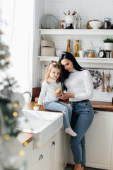 Mom and Little Daughter are preparing for the holiday and playing. Family, happiness.