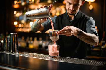 Male bartender preparing drink with sour mix