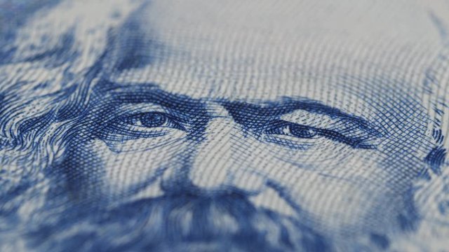 Karl Marx on East German banknote close up rotation. Founder of marxism and communism. Low angle. 4K stock video footage, 422 10 bit