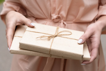 Girl with a gift. The book in his hands. Beige dress