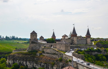 Fototapeta na wymiar Summer view on the old Kamianets-Podilskyi castle located in Khmelnytsky region of Ukraine. Kamianets-Podilskyi castle is very popular among tourists.
