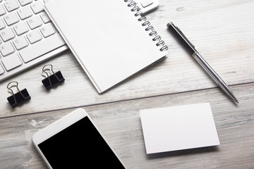 White desk office with laptop, smartphone and other work supplies with cup of coffee. Top view with copy space for input the text. Designer workspace on desk table essential elements on flat lay