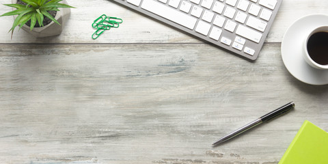 White desk office with laptop, smartphone and other work supplies with cup of coffee. Top view with...