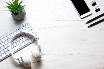 White desk office with laptop, smartphone and other work supplies with cup of coffee. Top view with...