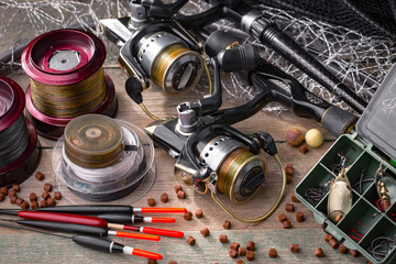 fishing tackle on a wooden table. toned image