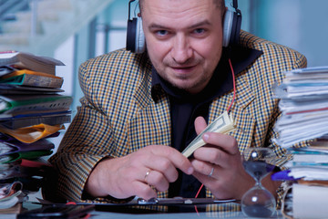 Very happy businessman with money in hand.