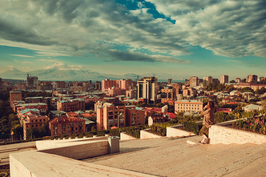 Yerevan cityscape from complex cascade. Touristic architecture landmark. City tour. Tourist woman Travel to Armenia. Tourism concept. Sunny autumn day. Mount Ararat on background. Copyspace
