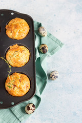 Savory muffins with bacon, quail egg, green onion and cheese on a light stone background. Protein breakfast. Paleo or keto diet.