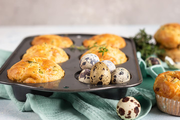 Savory muffins with bacon, quail egg, green onion and cheese on a light stone background. Protein breakfast. Paleo or keto diet.