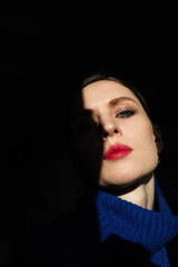 Creative portrait of young beautiful woman with red lips.