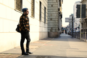 Young hipster walking in the street.