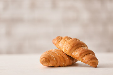 Tasty croissants on white table