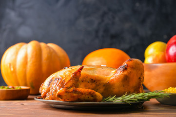 Tasty baked turkey and different food for Thanksgiving day on table