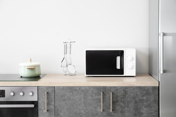 Fototapeta na wymiar Modern microwave oven in kitchen
