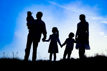 Fototapeta na wymiar happy family by the sea on nature silhouette background