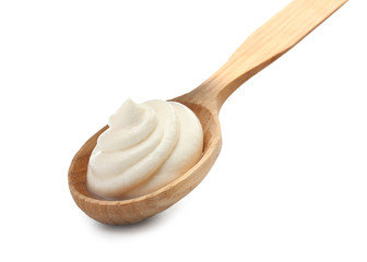 Spoon with tasty cream cheese on white background