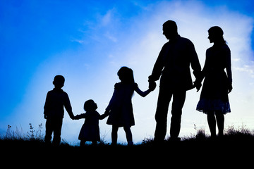 happy family by the sea on nature silhouette background