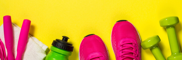 Fitness equipment flat lay image on color background.