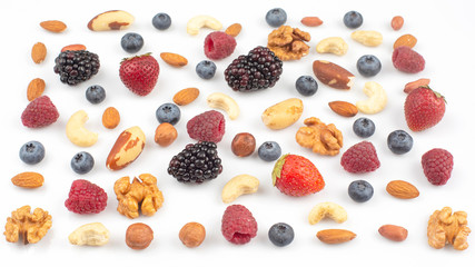 different berries and nuts on a white background. vitamin proteins and healthy foods