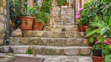 Fototapeta na wymiar Mediterranean summer cityscape - view of a medieval street with stairs in the Old Town of Dubrovnik on the Adriatic Sea coast of Croatia