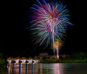 several colorful fireworks exploding in the dark night sky creating amazing light and color effects...