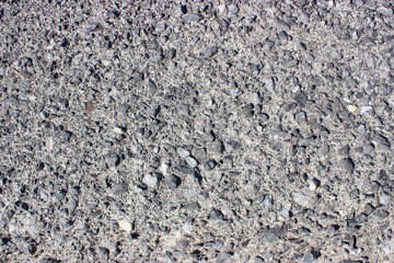 Crushed old asphalt pavement. Small gray-black pebbles.