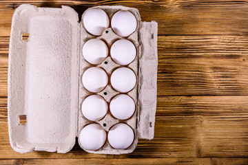 Pile of the hen eggs on wooden table. Top view