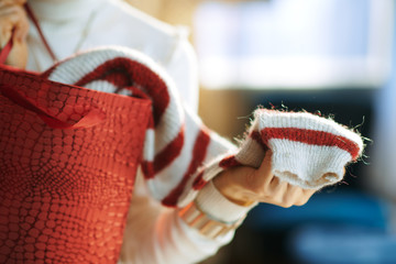 Closeup on woman with shopping bag checking purchased sweater