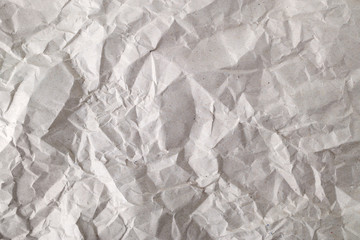 Texture of crumpled gray wrapping paper. Background of creased package paper. Empty grey crumpled paper. Copy space.