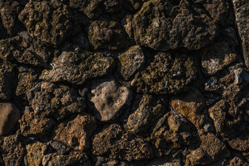 Stone texture. old rough stones tightly adjacent to each other. Dark stone floor or wall. Background from old stones.