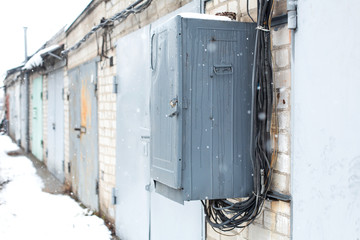Old electrical communications box hanging on a wall in a garage cooperative