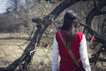 Girls dressed as medieval teaching archery at the field