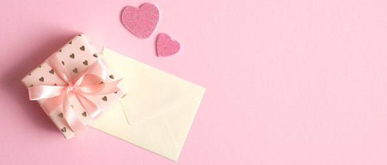 Valentines Day gift box and letter on pink background with hearts. Valentine's Day banner template, greeting card mockup. Flat lay, top view