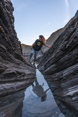 Deba, Gipuzkoa / Spain »; January 26, 2020: A young woman exploring the geopark of the Sakoneta coast one morning