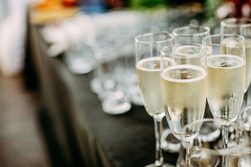 Lots of champagne glasses at an outdoor party.