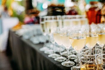 Lots of champagne glasses at an outdoor party