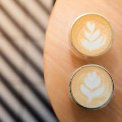 Coffee with a pattern on a foam in two glasses.