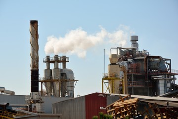 factory with smoke from chimneys