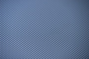 Perforated metal sheet on dark background