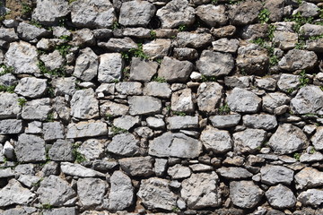  Part of an uneven stone wall with cement. Background, texture